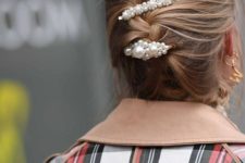 medium hair styled into a messy braided updo and accented with three matching pearl barrettes is a stylish idea
