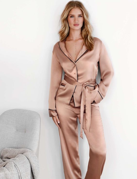 a dusty pink silk pajama with black edges is a stylish and very cool idea to wear at home, looks like a suit