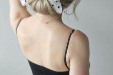 12 a simple twisted low chignon with a polka dot hair bow is a cool idea with a retro feel