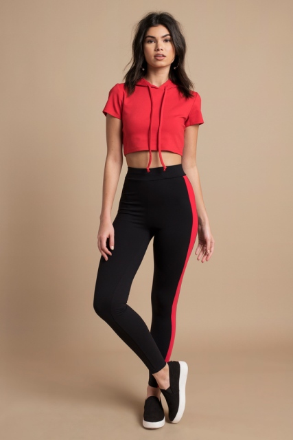 With black and red leggings and black and white slip on shoes