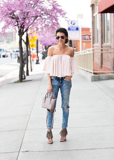 With cuffed jeans, gray bag and fringe shoes