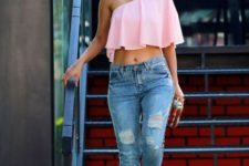 With distressed jeans, colorful clutch and pale pink pumps