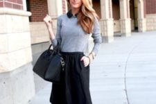 With gray sweater, black knee-length skirt and black bag