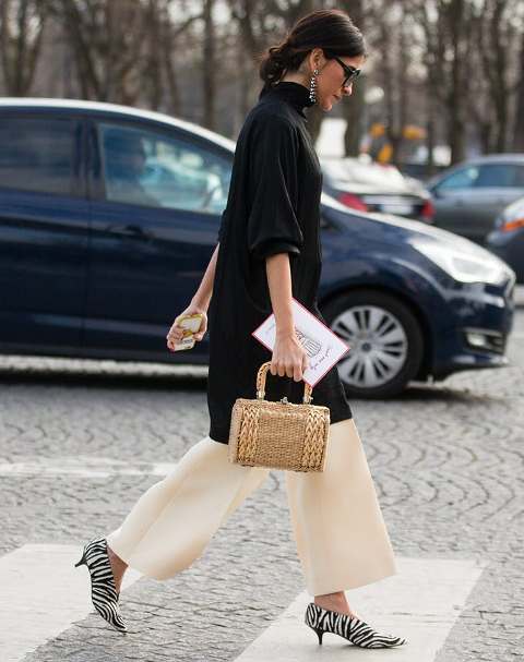 With long blouse, beige wide leg trousers and straw bag
