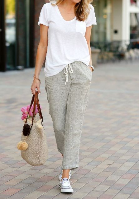 With loose t shirt, beige tote bag and white sneakers