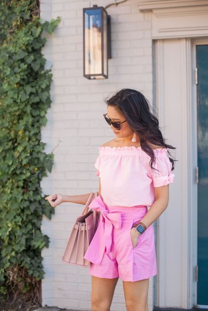 With pale pink bag and belted shorts