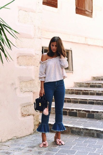With printed off the shoulder blouse, ruffled jeans and black bag