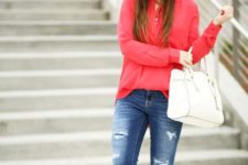 With red blouse, white bag and distressed jeans