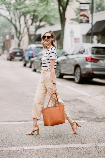 With white and black striped shirt, ankle strap shoes and brown tote bag