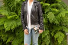 With white blouse, black leather jacket, floral clutch and distressed jeans
