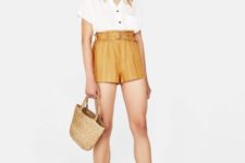 With white button down shirt, straw bag and white flat sandals