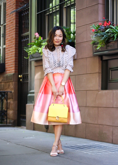 With white lace blouse, yellow bag and low heeled shoes