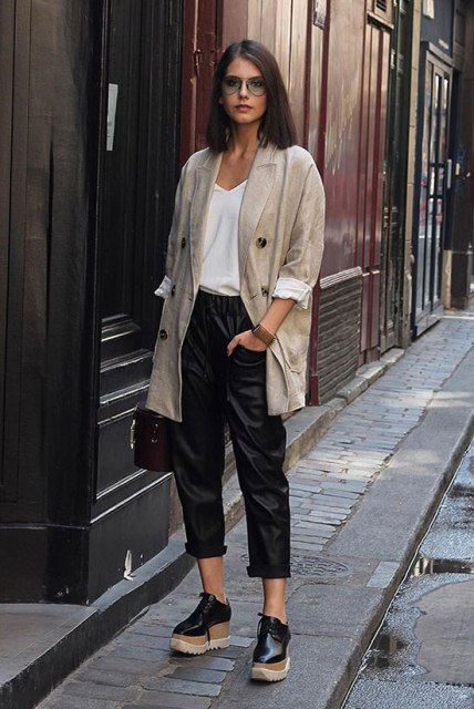 With white loose shirt, black leather cropped trousers, bag and platform lace up shoes
