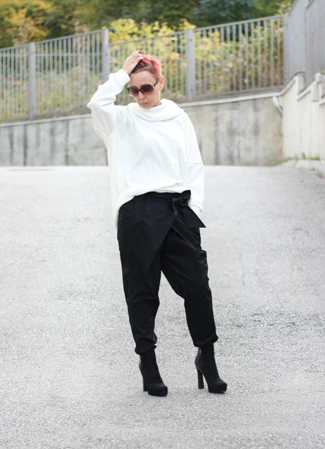 With white loose sweatshirt and black ankle boots