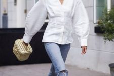 With white oversized blouse, beige bag and jeans