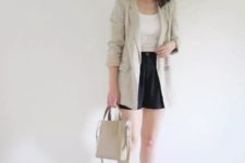 With white shirt, black shorts, beige bag and white sandals