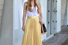 With white top, two colored bag and white heeled shoes