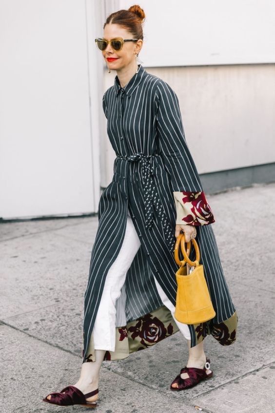 a black and white striped midi shirtdress, white pants, burgundy flats and a bucket bag in yellow
