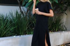 a black minimalist midi straight dress with a high neckline, short sleeves, side slits and white sneakers