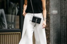 a black strap top, white culottes, black heels and a small bag for a chic summer look