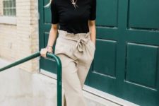 a black tee, neutral high waisted pants, tan flat mules for a very simple yet chic look