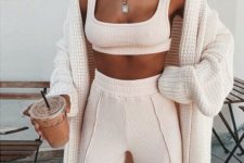 a blush pink loungewear set with a crop top and long pants plus a neutral oversized cardigan