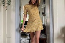 a bold mustard floral mini dress with a high neckline, short sleeves, hite socks and white sneakers for summer