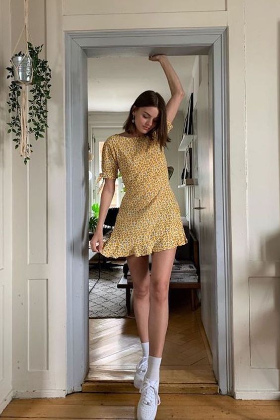 a bold mustard floral mini dress with a high neckline, short sleeves, hite socks and white sneakers for summer