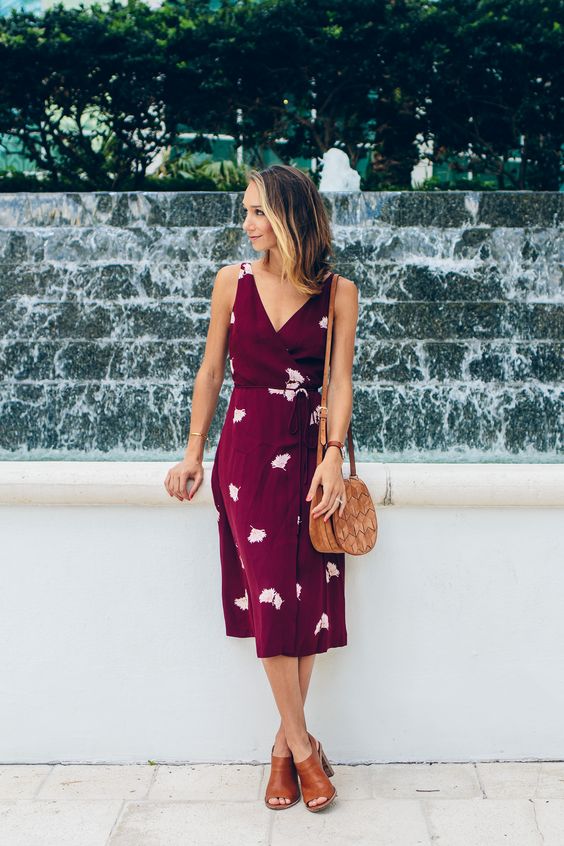 a comfortable purple floral wrap midi dress with thick straps and brown mules plus a saddle bag