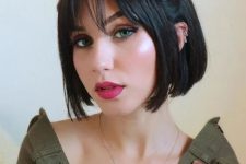 a jaw-line bob with cute top knots and wispy bangs is a stylish idea to look cute