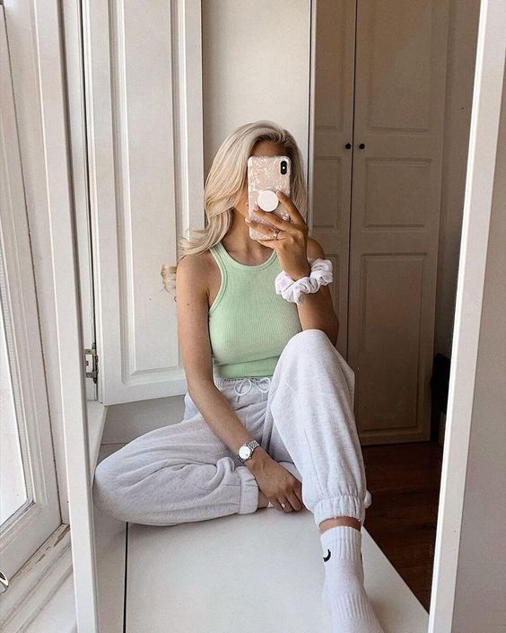 a light green halter neckline top, dove grey joggers, white socks for a sporty look at home