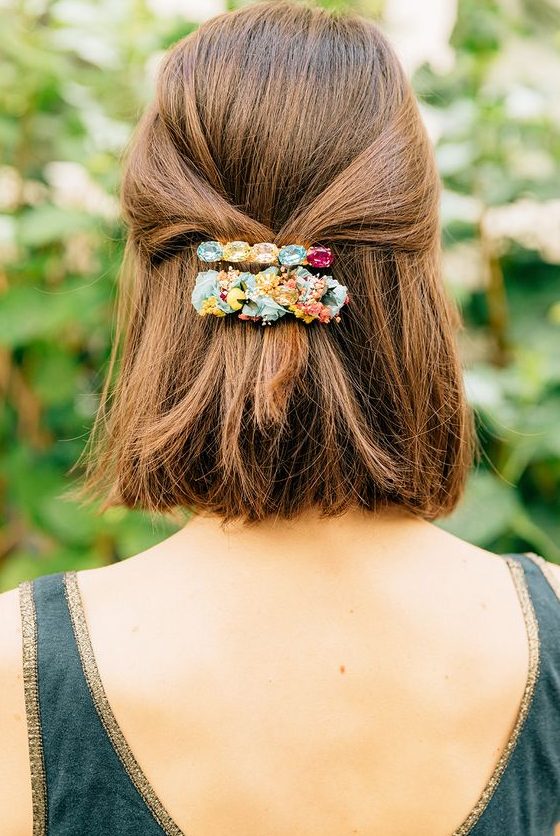 a lovely half updo with straight volumetric hair and colorful barrettes is a cool idea for holidays