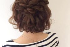 a messy and voluminous half updo with a loose double braid, a wavy top and waves down is a cool boho hairstyle