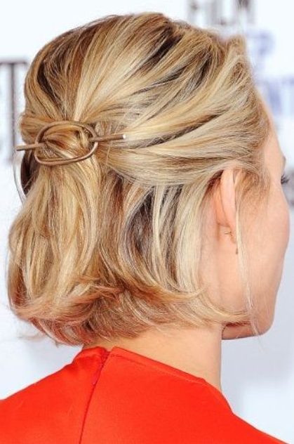 a midi blonde bob styled as a half updo, with a bump on top and a hair piece, with some volume on top
