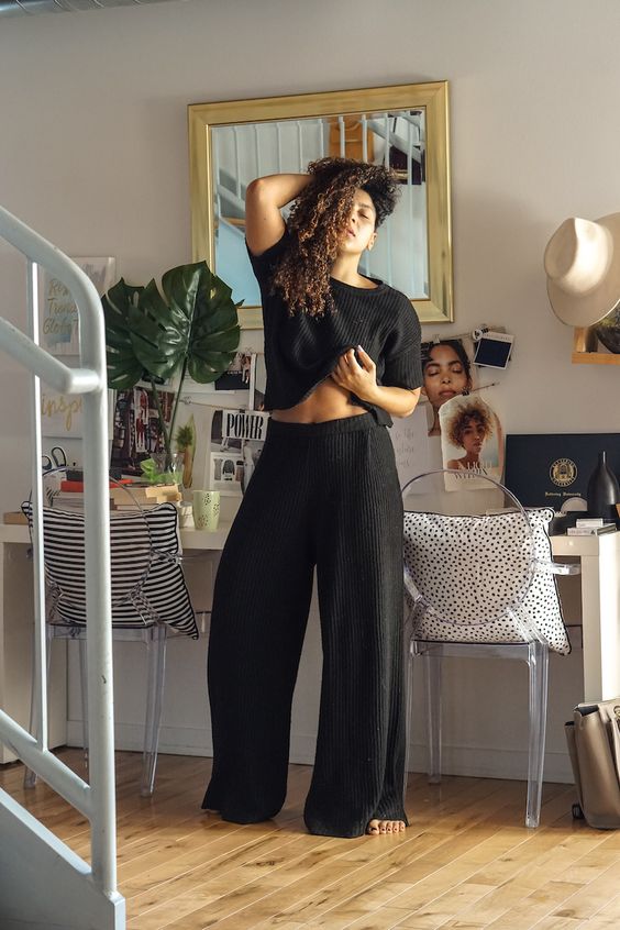 a minimalist black loungwear set with a crop top with short sleeves and wideleg pants is cool