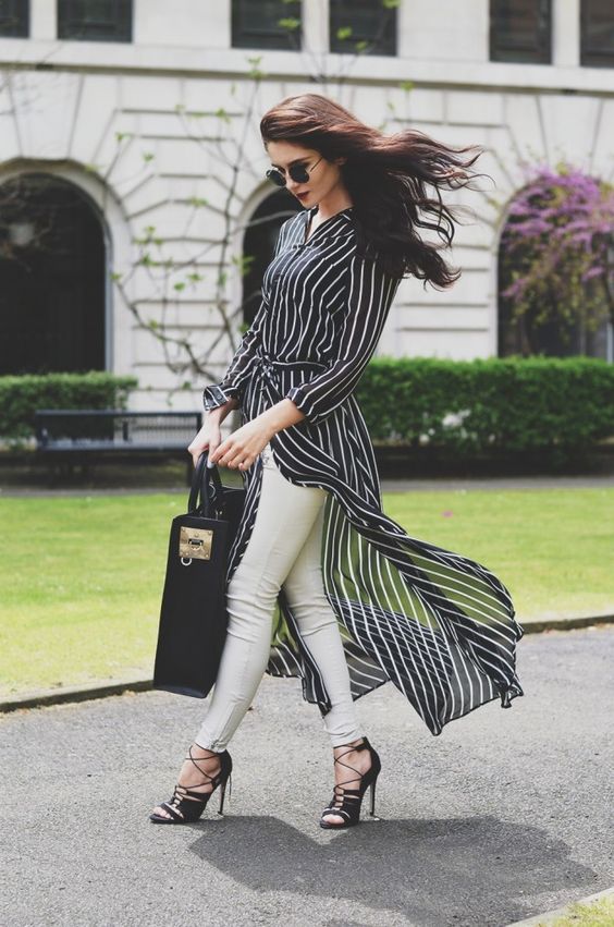 a monochromatic look with a black striped shirtdress, white skinnies, black lace up shoes and a statement black bag