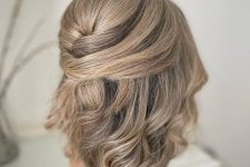 a pretty modern half updo with twisted touches and waves and a bump on top will fit medium hair length