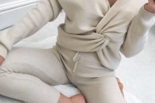 a sexy neutral loungewear set in off-white with an off the shoulder bow top and leggings