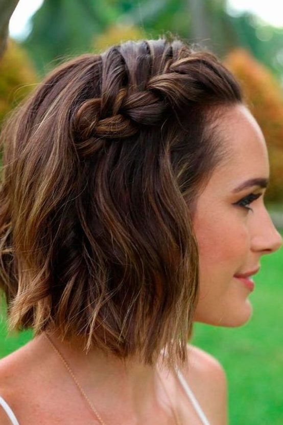 a short wavy bob with a waterfall braid on top for a trendy boho chic feel in your look