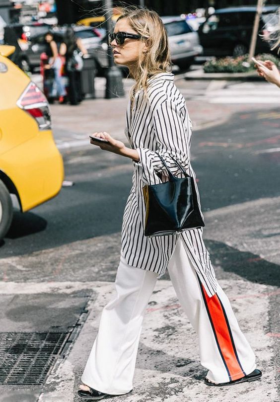 a striped knee shirtdress, white pants with red stripes, a black bag and black shoes