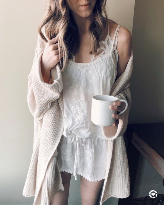 a white lacey night gown, a white lace bralette and a neutral cardigan for a chic and sexy look at home