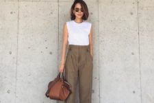 a white sleeveless top with a high neckline, brown high waisted pants, black heels and a brown bag for work