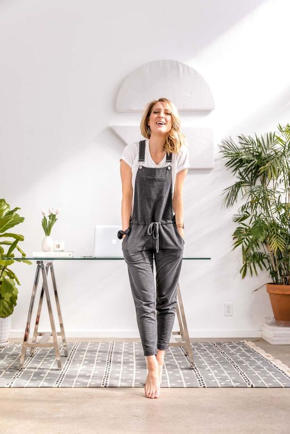 a white tee and a grey overalls with pockets make up a nice outfit for a casual day at home
