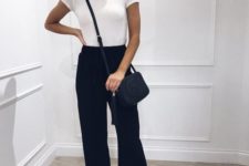a white tee, black cropped pants, white sneakers and a black crossbody for a monochromatic look