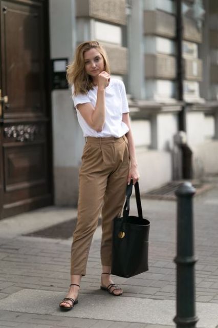 a white tee, brown cropped pants, black Greek sandals and a black bucket bag