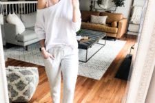 grey joggers, a white one shoulder top, a pink lace bralette and fluffy slippers for more comfort