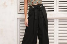 With black belted culottes and black ankle strap high heels
