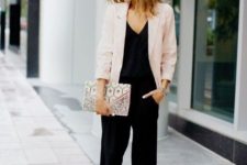 With black jumpsuit, printed clutch and beige pumps