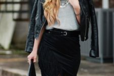 With gray shirt, black leather jacket and black clutch