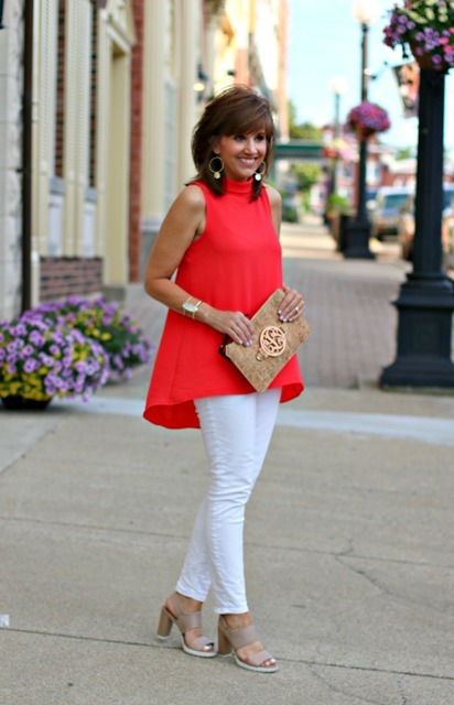 With gray shoes, white pants and beige embellished clutch